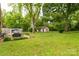Large backyard with mature trees, patio, shed, and lush lawn provides plenty of space at 7 Kings Mountain St, York, SC 29745