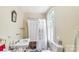 Charming bathroom with vintage clawfoot tub, pedestal sink, and bright natural light at 7 Kings Mountain St, York, SC 29745