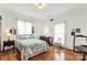 Light, airy bedroom with hardwood floors, quilt-covered bed and soft, natural lighting at 7 Kings Mountain St, York, SC 29745