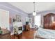 Charming bedroom with hardwood floors, fireplace, and an antique wardrobe at 7 Kings Mountain St, York, SC 29745