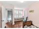 Bright bedroom with window seat, hardwood floors, and antique furnishings, showcasing cozy charm at 7 Kings Mountain St, York, SC 29745