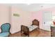 Cozy bedroom featuring classic wood bed frame, hardwood floors, and vintage accent chair at 7 Kings Mountain St, York, SC 29745