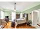 Comfortable bedroom featuring vintage furnishings, hardwood floors, and natural light from large windows at 7 Kings Mountain St, York, SC 29745
