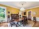 Formal dining room with a large table, elegant chandelier, and decorative wallpaper at 7 Kings Mountain St, York, SC 29745