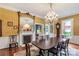 Spacious dining room with a fireplace, large mirror, and chandelier for formal gatherings at 7 Kings Mountain St, York, SC 29745