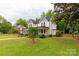 Quaint two-story house is nestled amongst lush greenery with a well-maintained lawn and welcoming facade at 7 Kings Mountain St, York, SC 29745