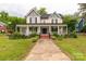 Lovely two-story home features a wide front porch and classic architectural elements in a landscaped setting at 7 Kings Mountain St, York, SC 29745