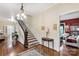 Elegant foyer showcases a staircase with hardwood floors and views into other living spaces at 7 Kings Mountain St, York, SC 29745