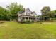 Charming two-story house boasts a large front yard with mature trees and a classic, inviting exterior at 7 Kings Mountain St, York, SC 29745