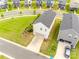 An aerial view shows the home situated with a backyard, driveway, garage, and neighboring houses at 700 Windage Way, Pineville, NC 28134