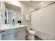Well-lit bathroom featuring a modern vanity, mirror, toilet, and shower, providing a clean and functional space at 700 Windage Way, Pineville, NC 28134