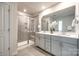 Modern bathroom featuring a double sink vanity, walk-in shower, and tile flooring at 700 Windage Way, Pineville, NC 28134