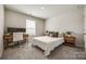 Serene bedroom featuring a comfortable bed, stylish nightstands, and a dedicated workspace, perfect for relaxation and productivity at 700 Windage Way, Pineville, NC 28134
