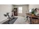 Bright bedroom with a bike and desk offers a quiet workspace with natural light creates an ideal work-from-home environment at 700 Windage Way, Pineville, NC 28134