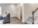 Open foyer featuring hardwood floors, staircase, and convenient access to a powder room at 700 Windage Way, Pineville, NC 28134