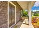 Covered porch with brick, stylish seating, and a welcoming front door at 700 Windage Way, Pineville, NC 28134