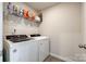 Bright laundry room featuring a washer, dryer, and shelving for convenient storage solutions at 700 Windage Way, Pineville, NC 28134