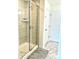 Clean bathroom features a glass-enclosed shower with neutral tile and built-in shelving at 7024 Wheyfield Dr, Charlotte, NC 28215
