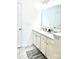Bathroom with double sink vanity with white countertop and cabinets, complemented by grey floor tile at 7024 Wheyfield Dr, Charlotte, NC 28215