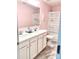 Bathroom with a dual sink vanity with white cabinets and pink walls, complemented by marble-style flooring at 7024 Wheyfield Dr, Charlotte, NC 28215