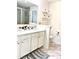 Bright bathroom features a double sink vanity with a white countertop and white cabinets, a walk-in shower, and modern fixtures at 7024 Wheyfield Dr, Charlotte, NC 28215