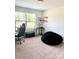 Bedroom featuring a beanbag chair, desk, and neutral walls with a window allowing ample natural light at 7024 Wheyfield Dr, Charlotte, NC 28215