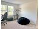 Bedroom featuring a beanbag chair, desk, and neutral walls with a window allowing ample natural light at 7024 Wheyfield Dr, Charlotte, NC 28215