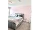 Bedroom featuring carpeted floors, neutral wall paint, and a sizable bed with gray upholstered headboard at 7024 Wheyfield Dr, Charlotte, NC 28215