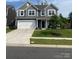 This two story home features a two car garage and manicured front yard at 7024 Wheyfield Dr, Charlotte, NC 28215