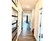 The hallway has wood floors that lead to the kitchen, living room, and other rooms of the house at 7024 Wheyfield Dr, Charlotte, NC 28215