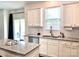 Bright kitchen features granite counters, white cabinets, stainless appliances, and an island with sink at 7024 Wheyfield Dr, Charlotte, NC 28215