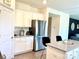 Well-lit kitchen featuring granite counters, stainless appliances and island seating at 7024 Wheyfield Dr, Charlotte, NC 28215