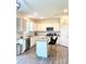 Well-lit kitchen features granite counters, white cabinets, stainless appliances, and island seating at 7024 Wheyfield Dr, Charlotte, NC 28215