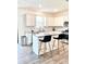 Bright kitchen features granite counters, white cabinets, stainless appliances, and island with seating at 7024 Wheyfield Dr, Charlotte, NC 28215