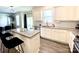The modern kitchen has white cabinets, granite countertops, and a large island with bar stools at 7024 Wheyfield Dr, Charlotte, NC 28215