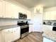 A kitchen with white cabinets, stainless steel appliances, and granite countertops at 7024 Wheyfield Dr, Charlotte, NC 28215