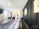 Inviting living room with modern decor open to the eat-in kitchen and sliding glass doors at 7024 Wheyfield Dr, Charlotte, NC 28215