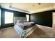 Main bedroom features tray ceiling, dark accent wall, and plush upholstered platform bed at 7024 Wheyfield Dr, Charlotte, NC 28215