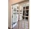 An office with french doors, neutral carpet and paint, and modern furnishings at 7024 Wheyfield Dr, Charlotte, NC 28215