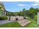 Beautiful backyard patio with string lights, pergola, and stone pavers at 7331 Millstone Sw Cir, Concord, NC 28025