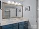 Bathroom featuring double sinks, an oversized framed mirror, and modern fixtures at 7331 Millstone Sw Cir, Concord, NC 28025