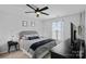 Bedroom featuring a bed, a large window, modern decor, and a ceiling fan at 7331 Millstone Sw Cir, Concord, NC 28025
