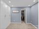 Bedroom view featuring a built-in closet and an open door to a walk-in closet for storage at 7331 Millstone Sw Cir, Concord, NC 28025