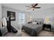 Bedroom featuring a ceiling fan, a window, modern décor, and a comfortable bed at 7331 Millstone Sw Cir, Concord, NC 28025