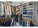 Closet with neatly organized shelves and hanging rods, perfect for storing a variety of clothing at 7331 Millstone Sw Cir, Concord, NC 28025