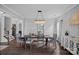 Formal dining room with elegant chandelier, hardwood floors, and stylish decor at 7331 Millstone Sw Cir, Concord, NC 28025