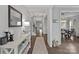 Elegant hallway featuring hardwood floors, decorative lighting, and neutral paint scheme at 7331 Millstone Sw Cir, Concord, NC 28025