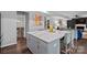 Open concept view of kitchen with large marble island and views into the living area at 7331 Millstone Sw Cir, Concord, NC 28025