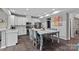 Spacious kitchen with white cabinets, stainless steel appliances, and large center island at 7331 Millstone Sw Cir, Concord, NC 28025