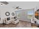 Bright living room featuring a white brick wall, stylish decor, and wood flooring at 7331 Millstone Sw Cir, Concord, NC 28025